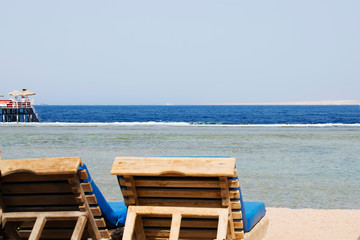 Sea shore. Vacation on the beach chair by the blue ocean. Relax time.