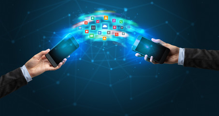Two mobile phones syncing applications concept