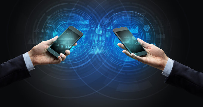 Close up of two smartphones syncing business data