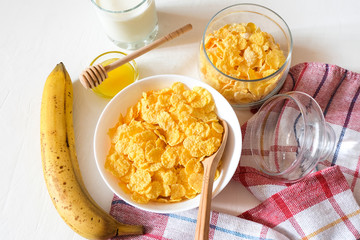 Traditional cereal of cornflakes and milk with a banana. Healthy lifestyle food.