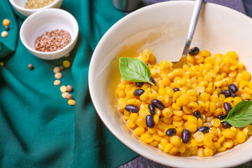 Bowl with tasty boiled legumes on table