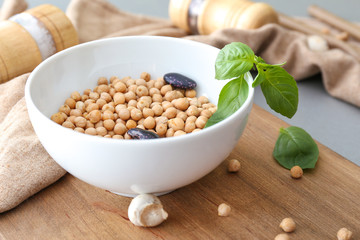 Bowl with raw legumes on table