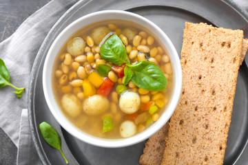 Tasty soup with legumes in bowl on table