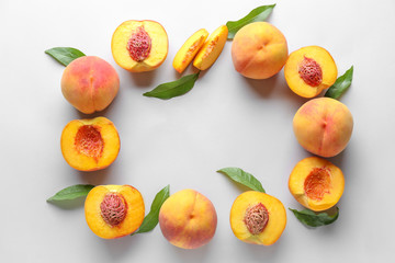 Fototapeta na wymiar Frame made of ripe peaches on light background