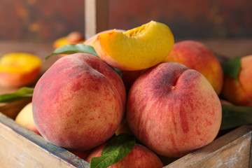 Ripe peaches in wooden box, closeup