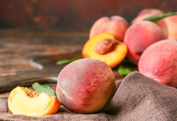 Ripe juicy peaches on table