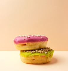 two round donuts with sprinkles