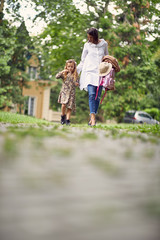 Obraz premium first day at school over, parent and girl going home from school