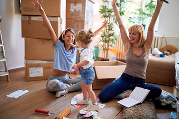 Woman’s enjoying in new house with child girl.