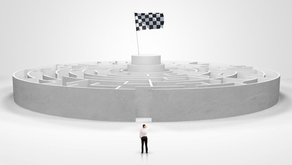 Man standing in front of a big round maze with flag