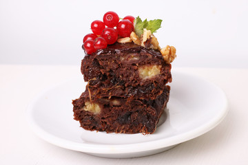 chocolate cake, decorated red currants, nuts and mint
