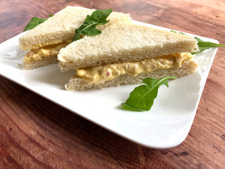 Tramezzini is a classic, Italian sandwich. Sliced white bread with egg spread. Tramezzinis are offered as a snack or appetizer.