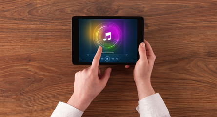 Fototapeta na wymiar Hand touching tablet with music play concept