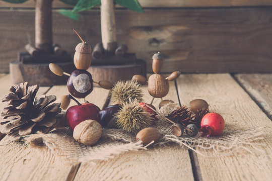 autumn tinker figures on wooden background