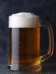 Beer mug with light beer on dark background