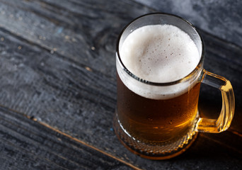 Beer mug with light beer on dark background