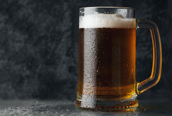 Beer mug with light beer on dark background