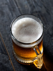 Beer mug with light beer on dark background
