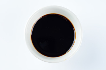 Thick dark soy sauce on a light background