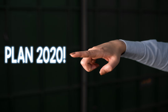 Text sign showing Plan 2020. Business photo showcasing detailed proposal for doing or achieving something next year Finger pointing in the Dark with hand pointing in the copy space