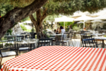 Table background with blurred restaurant view. Empty space for advertising products and decoration.