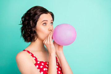 Photo of pretty lady with air ballon in mouth wear red dotted dress isolated teal background