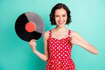 Photo of charming cool marvelous lovely nice cute girl holding vinyl plate and surprising that such stuff is still existing while isolated with teal background