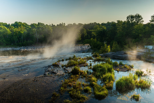 morning mist rising from waterfall