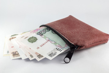Russian ruble in a leather bag on a white background.
