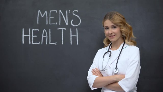 Doctor standing near Mens health inscription, importance of annual physical exam
