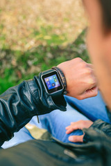 Fototapeta premium Detail of hand of unrecognizable young man looking at his smartwatch