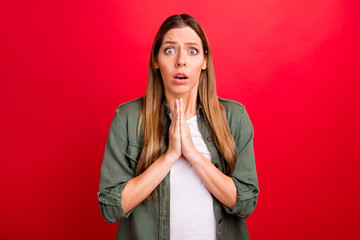 Photo of cute disappointed sad girl wearing green shirt begging you to stop while isolated with red...