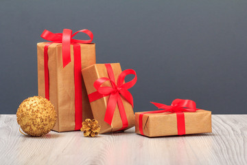 Gift boxes and toy ball on wooden boards and gray background