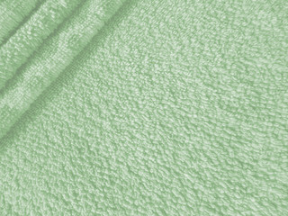 A stack of bath towels. Pattern for design fabric texture.  Сopy space.  Light green colors background. 