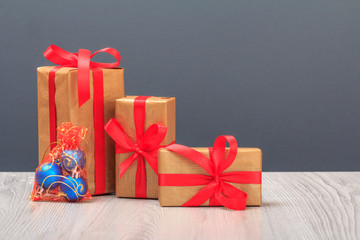 Gift boxes, toy balls on gray background