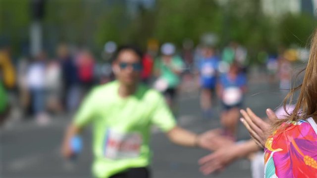 Giving runners high five in 4k slow motion 60fps