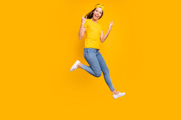Fototapeta na wymiar Full body photo of beautiful lady jumping high rejoicing at metal concert wear casual clothes isolated yellow background