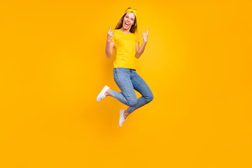 Fototapeta na wymiar Full body photo of beautiful lady jumping high rejoicing at metal concert wear casual clothes isolated yellow background