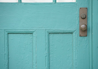 Front door of a house painted in green paint