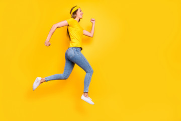 Fototapeta na wymiar Full length photo of pretty lady jumping high jogging wear casual clothes isolated yellow background