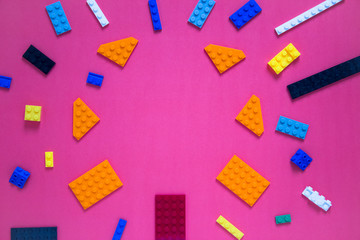 Background for children's site, for the menu. Children's constructors on pink. Multi-colored cubes. Games for motor developing memory and mind.