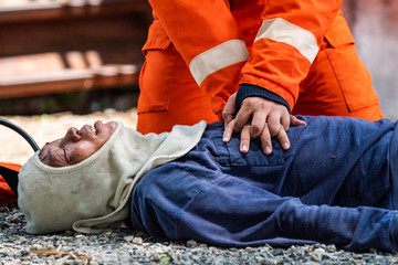 Medium shot of firefighter in fire suit on safety rescue duty help stop breathing heart attack man...