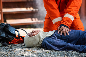 Medium shot of firefighter in fire suit on safety rescue duty help stop breathing heart attack man...