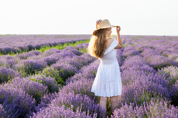 Woman in a white dress in a lavender field.