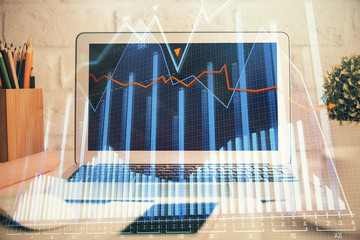 Financial graph colorful drawing and table with computer on background. Double exposure. Concept of...