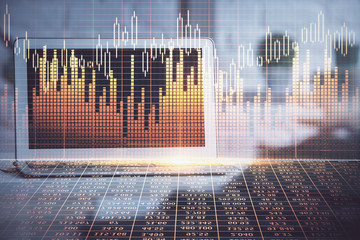 Double exposure of chart and financial info and work space with computer background. Concept of international online trading.