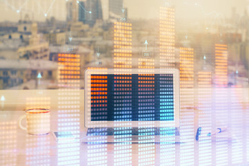 Financial market graph hologram and personal computer on background. Double exposure. Concept of forex.