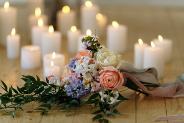 wedding bouquet on the floor with many candles