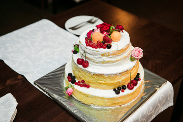 wedding cake with fruit and a plate with a fork and a knife