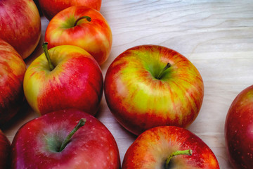 Fresh red apples, on a wooden table, the background is a table made of light oak. free space for text, view from the top
